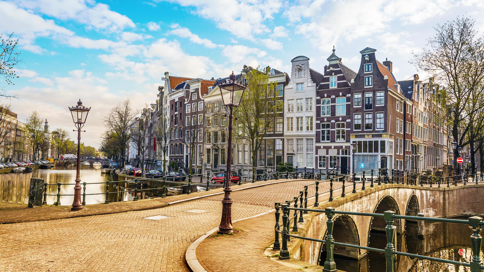 a bridge over a canal with buildings and a bridge