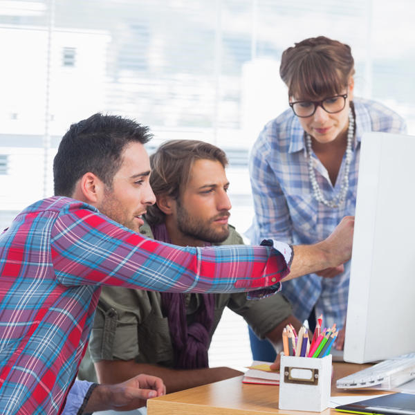 a group of people looking at a computer screen