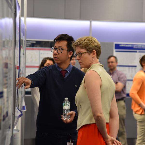 a man pointing at a woman on a white board