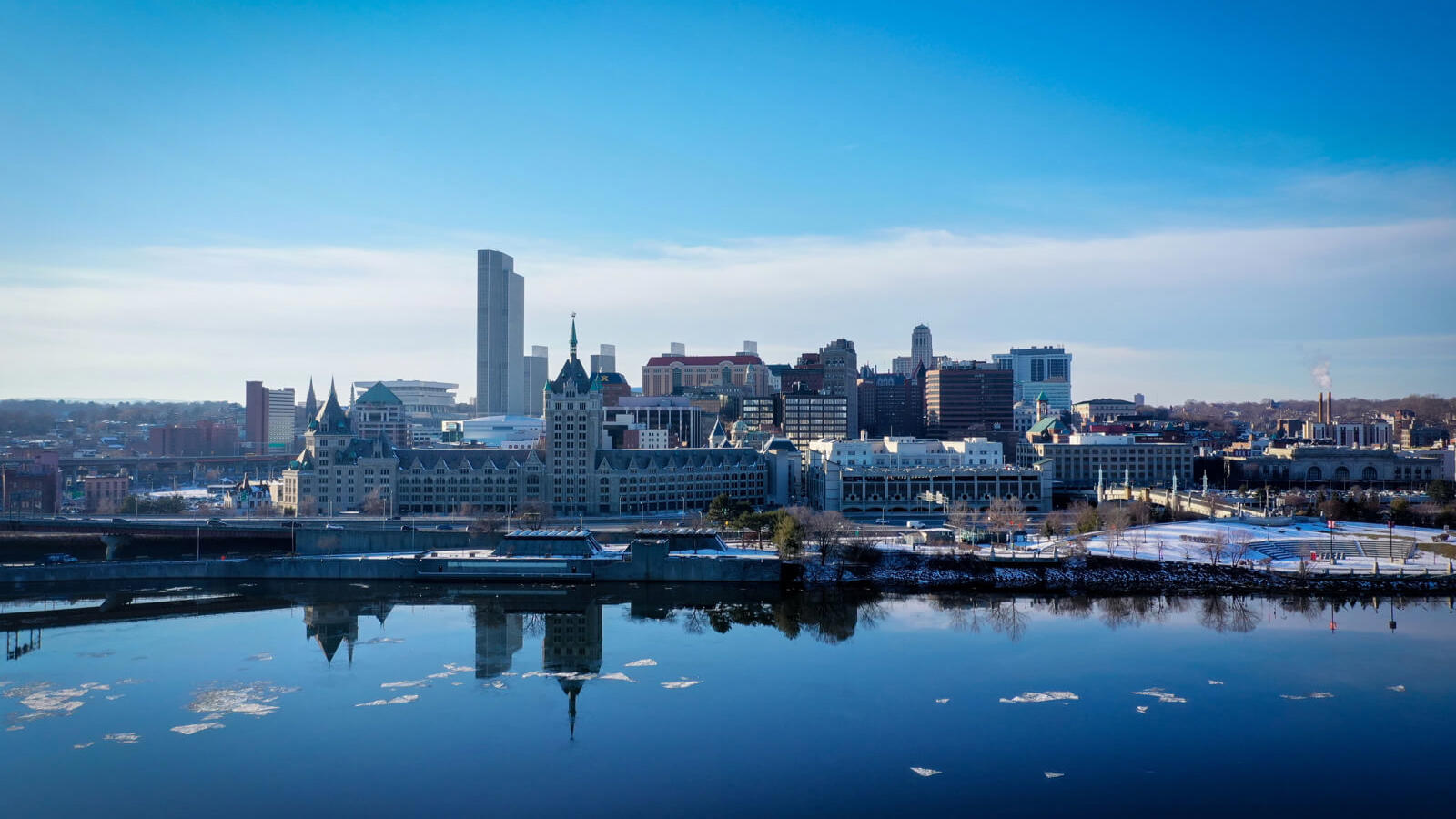 a city skyline with a body of water